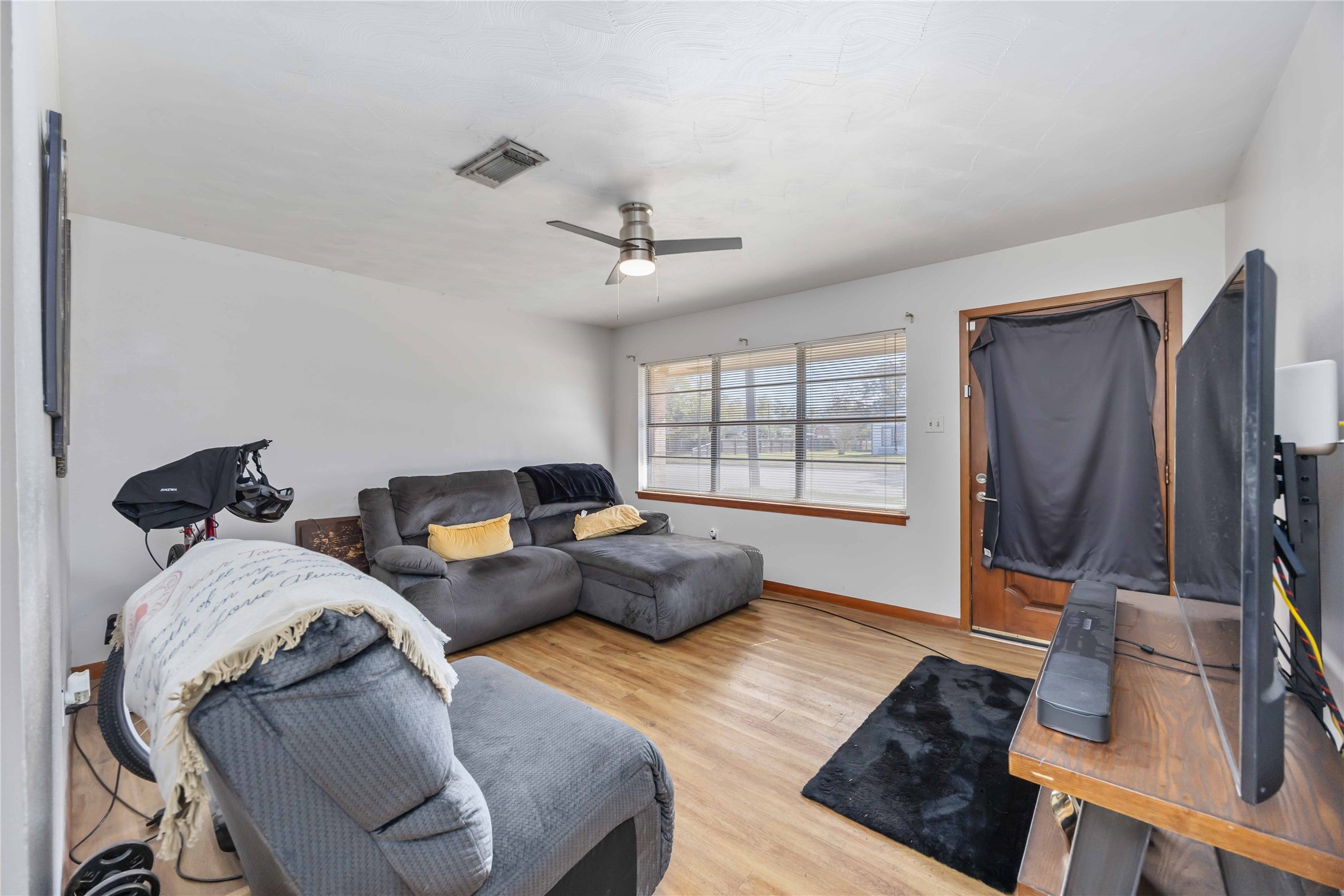 615 Massey Tompkins Road Baytown, TX 77521 - Photo 4 of 25 a living room with furniture a flat screen tv and a window