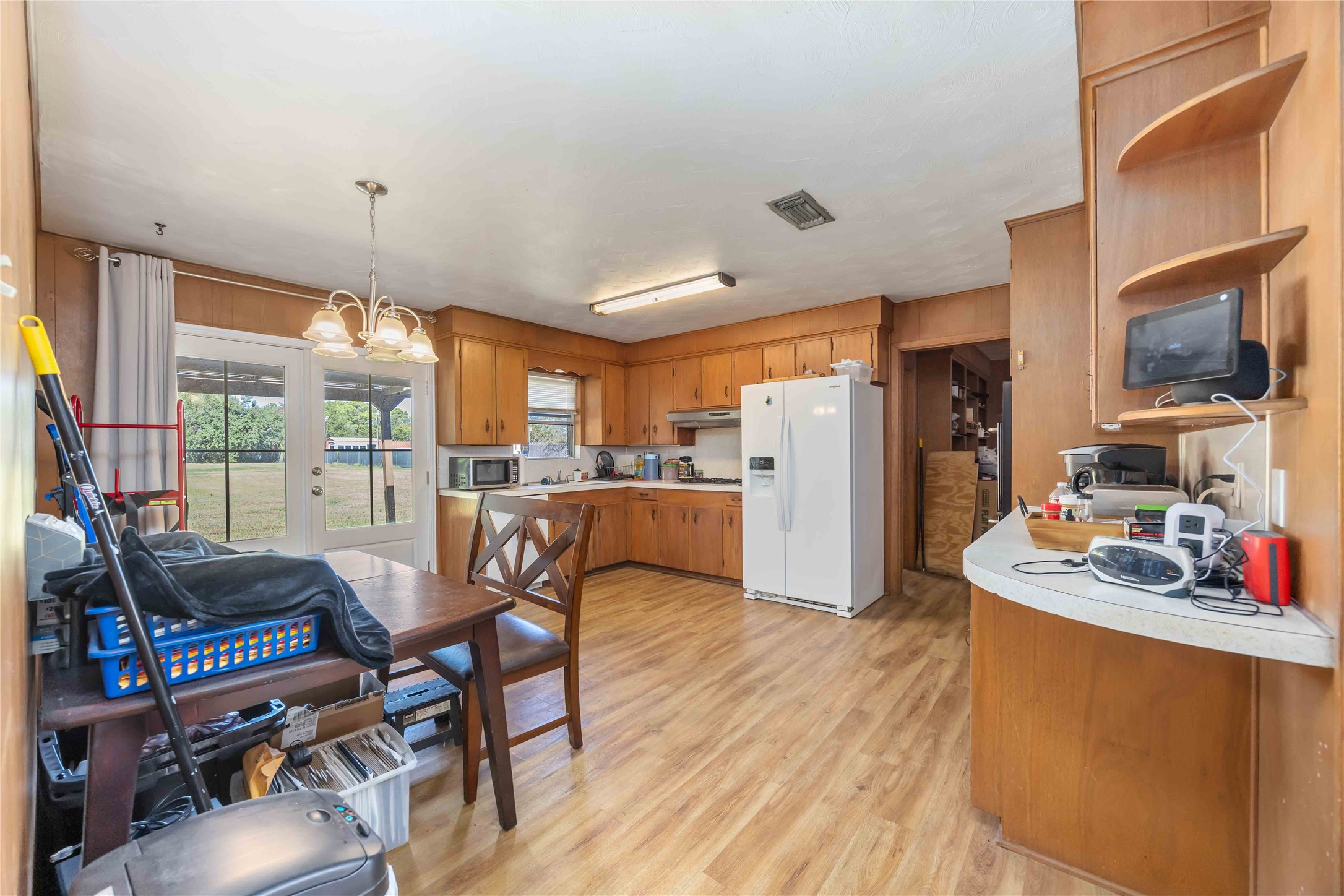 615 Massey Tompkins Road Baytown, TX 77521 - Photo 9 of 25 a kitchen with stainless steel appliances wooden floor and refrigerator