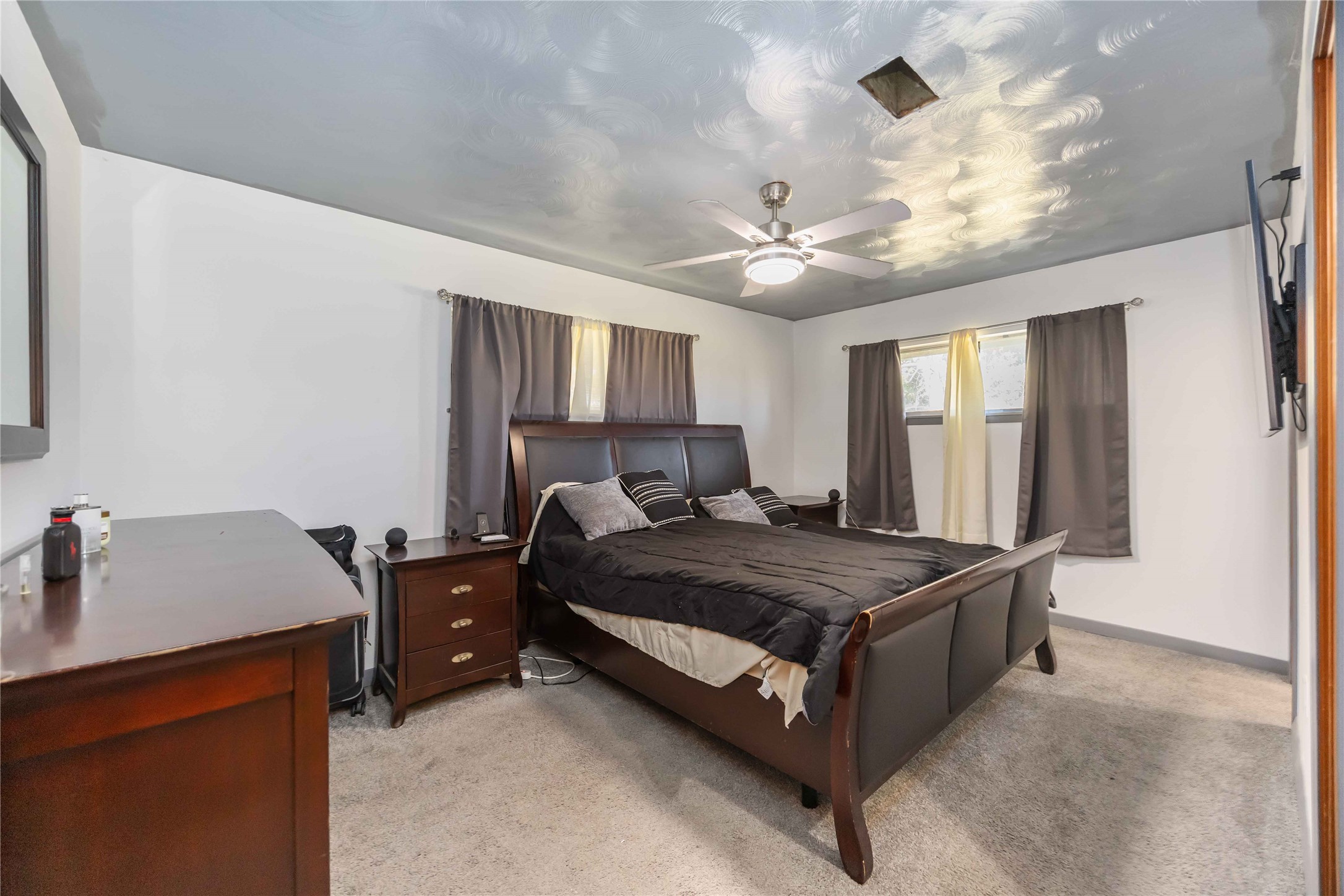 615 Massey Tompkins Road Baytown, TX 77521 - Photo 10 of 25 a bed room with a bed and a chandelier