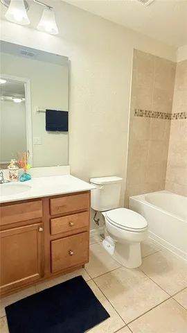 a bathroom with a toilet and a bath tub