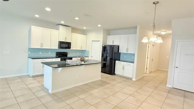 a kitchen with stainless steel appliances a refrigerator sink and microwave