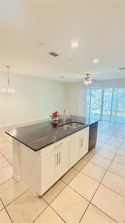 7580 Aloma Pines Court Winter Park, FL 32792 - Photo 6 of 36 a large kitchen with granite countertop a stove a sink and white cabinets with granite countertops