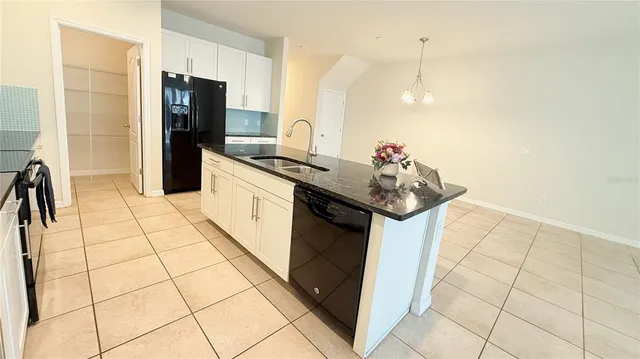 a kitchen with stainless steel appliances a sink and a refrigerator