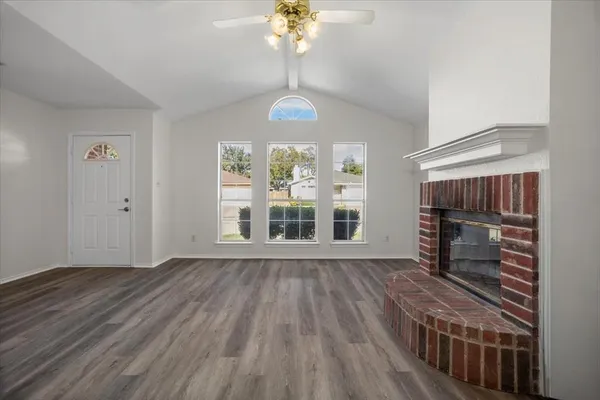 wooden floor in an empty room with a window