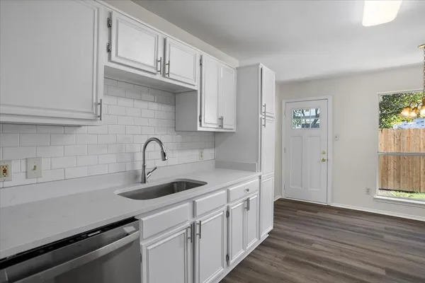 a kitchen with stainless steel appliances granite countertop a sink and wooden cabinets
