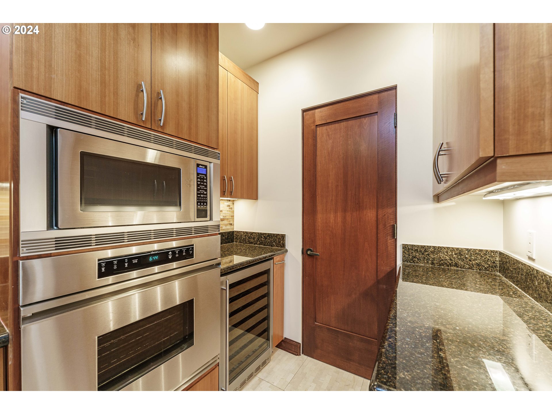 3030 Northwest Montara Loop Portland, OR 97229 - Photo 12 of 37 a kitchen with granite countertop a refrigerator stove and microwave