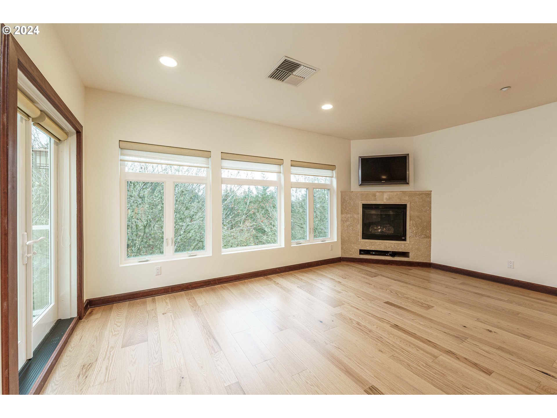 3030 Northwest Montara Loop Portland, OR 97229 - Photo 13 of 37 a view of empty room with wooden floor and fireplace