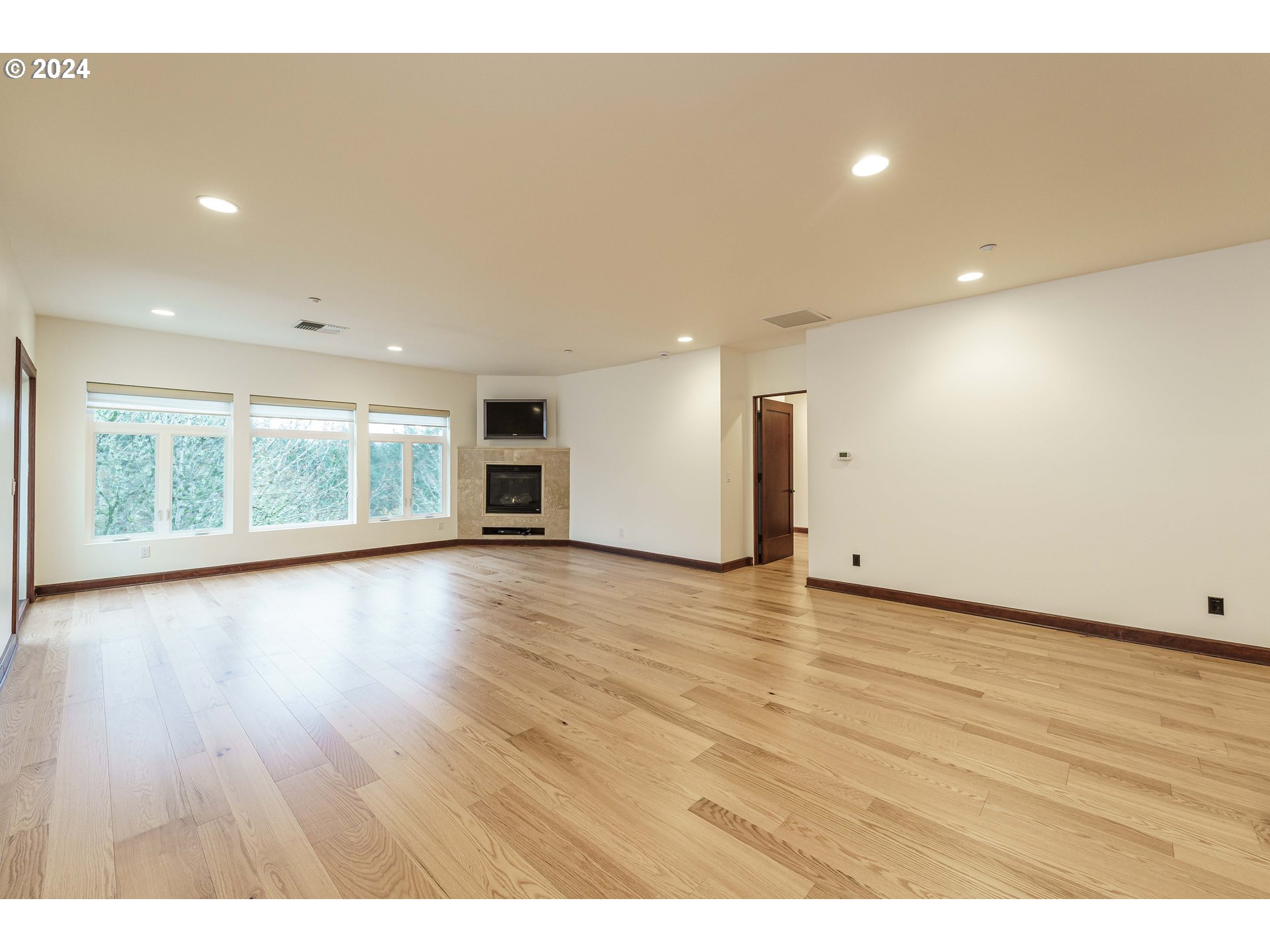 3030 Northwest Montara Loop Portland, OR 97229 - Photo 14 of 37 a view of an empty room with wooden floor and a window