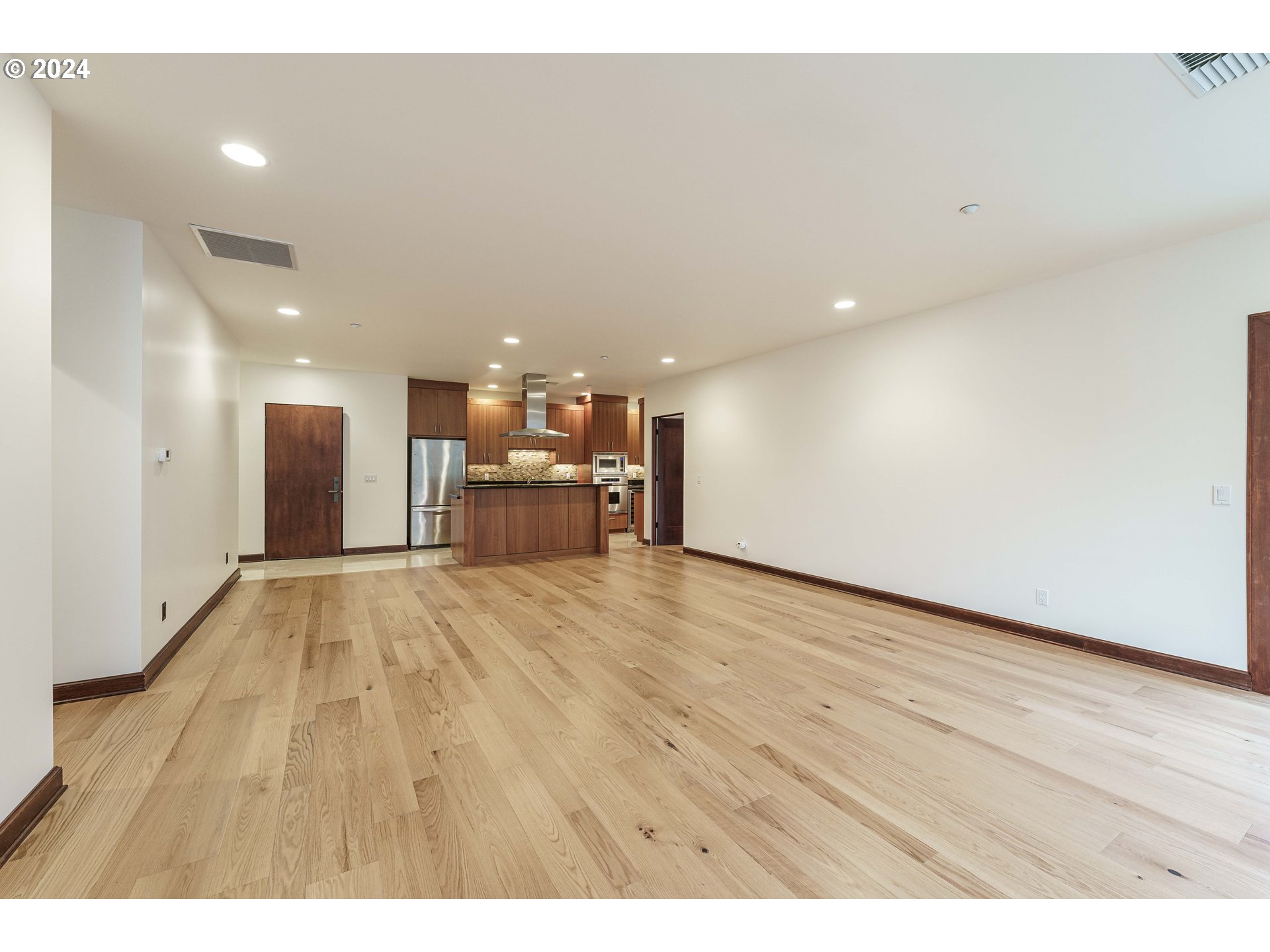 3030 Northwest Montara Loop Portland, OR 97229 - Photo 17 of 37 a view of kitchen and a hallway with wooden floor