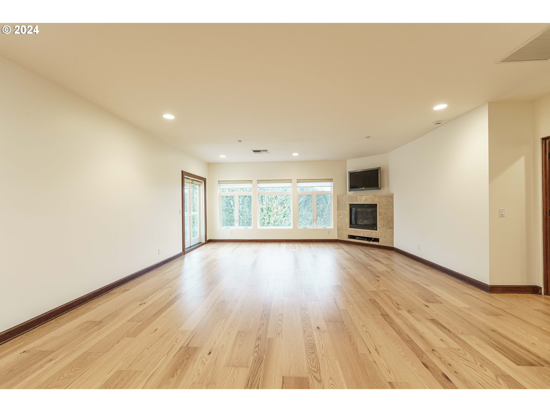 3030 Northwest Montara Loop Portland, OR 97229 - Photo 18 of 37 a view of an empty room with wooden floor and a window