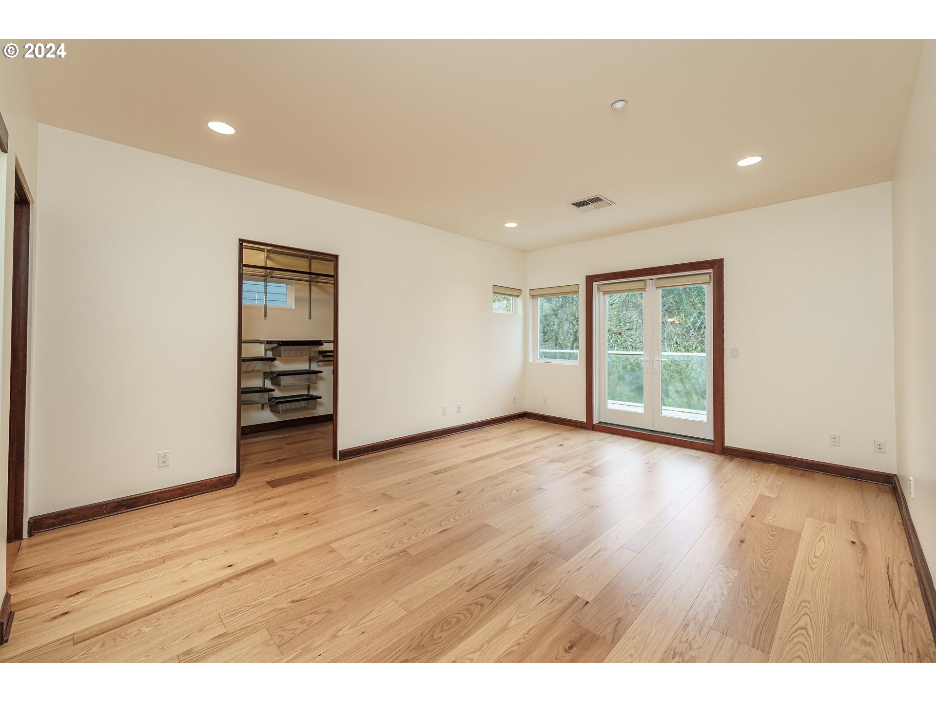 3030 Northwest Montara Loop Portland, OR 97229 - Photo 20 of 37 an empty room with wooden floor and windows