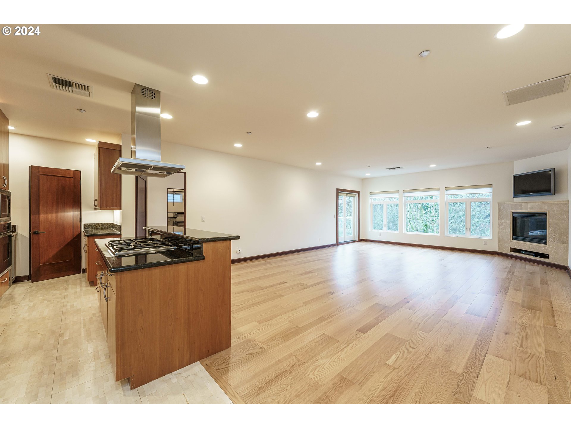 3030 Northwest Montara Loop Portland, OR 97229 - Photo 6 of 37 a kitchen with stainless steel appliances granite countertop a refrigerator a stove and a wooden floors