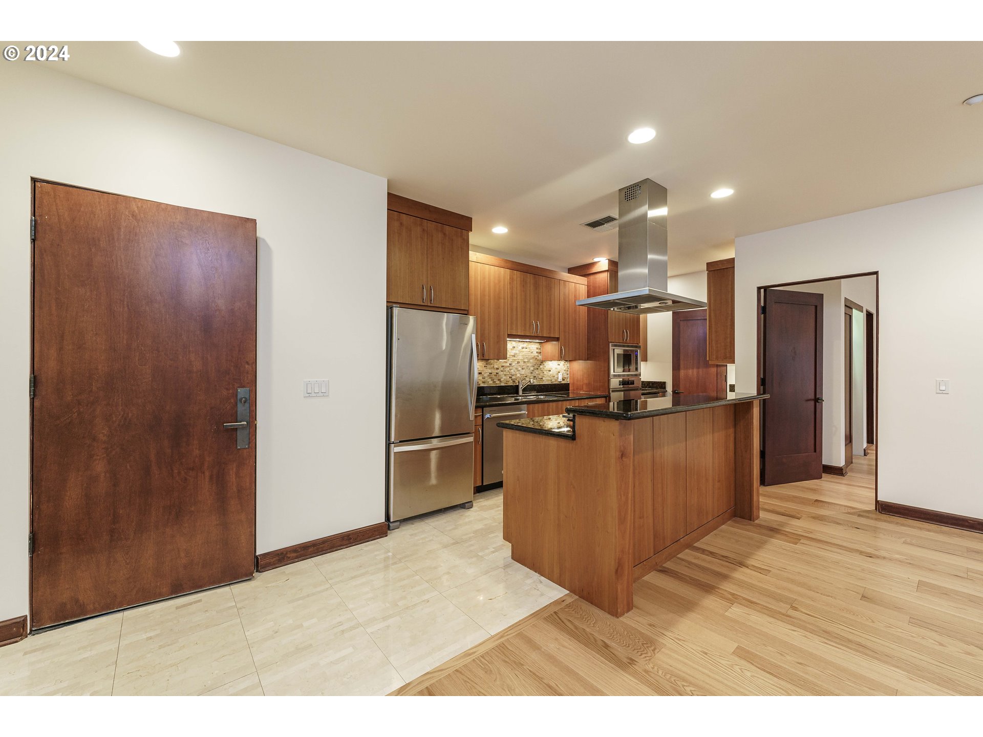3030 Northwest Montara Loop Portland, OR 97229 - Photo 7 of 37 a kitchen with stainless steel appliances kitchen island granite countertop a refrigerator and a sink