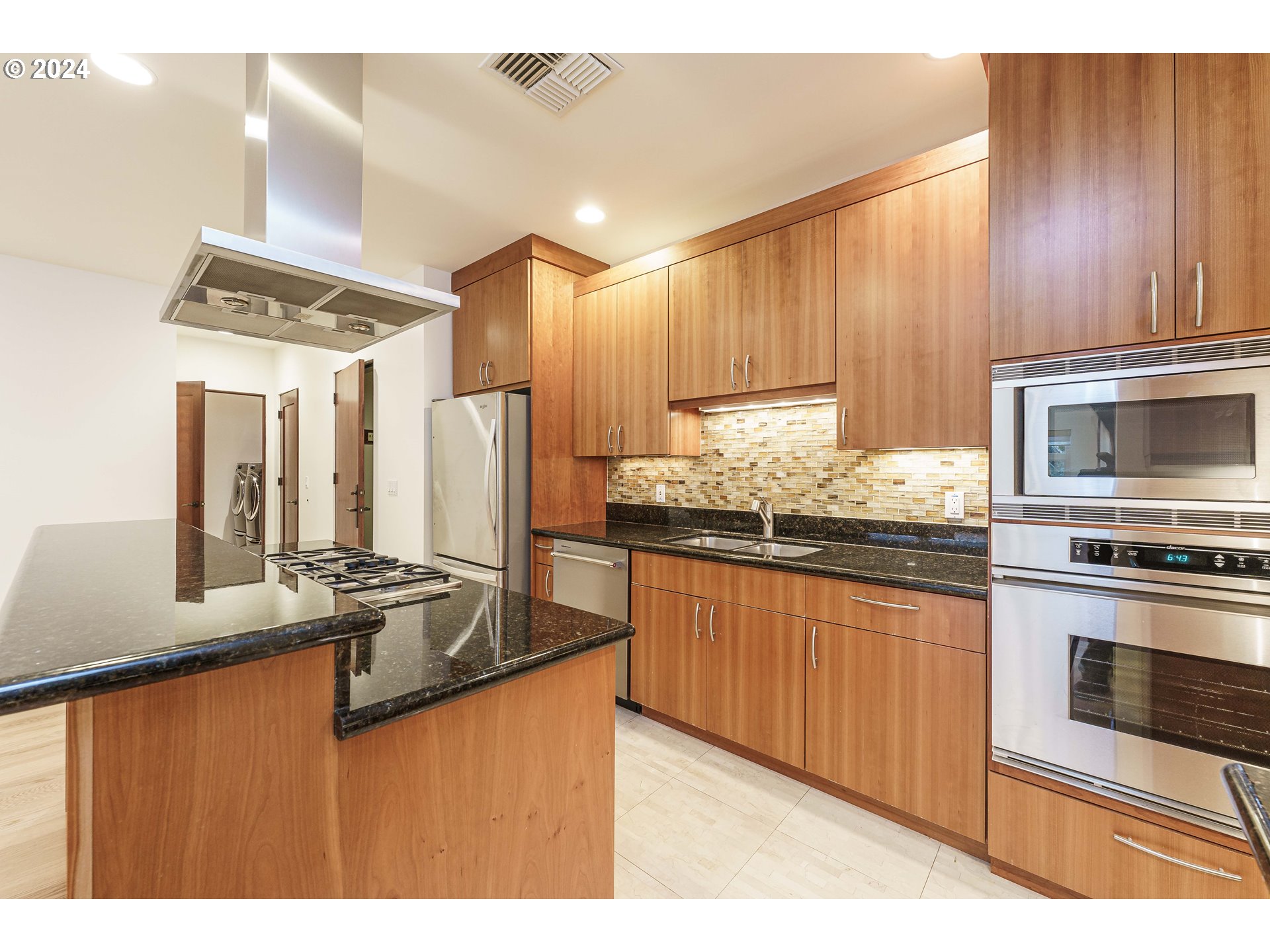 3030 Northwest Montara Loop Portland, OR 97229 - Photo 8 of 37 a kitchen with stainless steel appliances granite countertop a stove refrigerator and cabinets