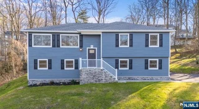 a front view of a house with a garden