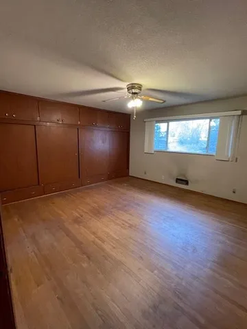 an empty room with a fireplace and window