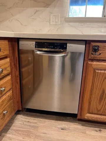 a stove top oven sitting inside of a kitchen