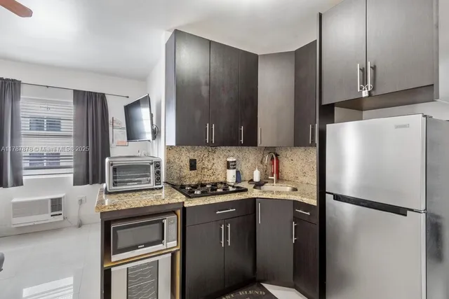 a kitchen with stainless steel appliances a refrigerator stove and sink