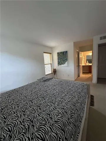 a bedroom with bed and window