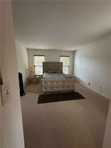 a bedroom with a bed and window