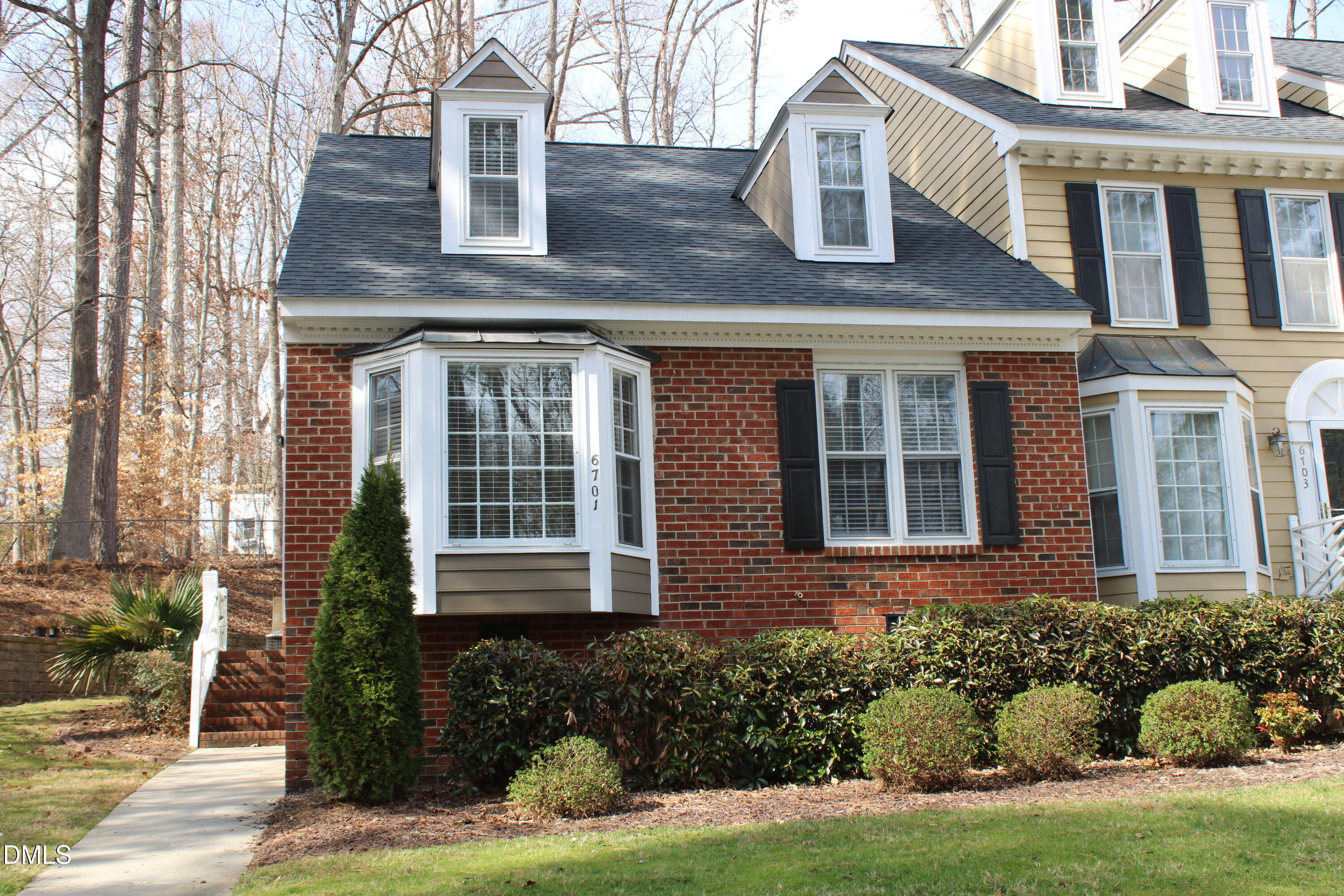 6701 Queen Annes Drive Raleigh, NC 27613 - Photo 1 of 23 a front view of a house with garden