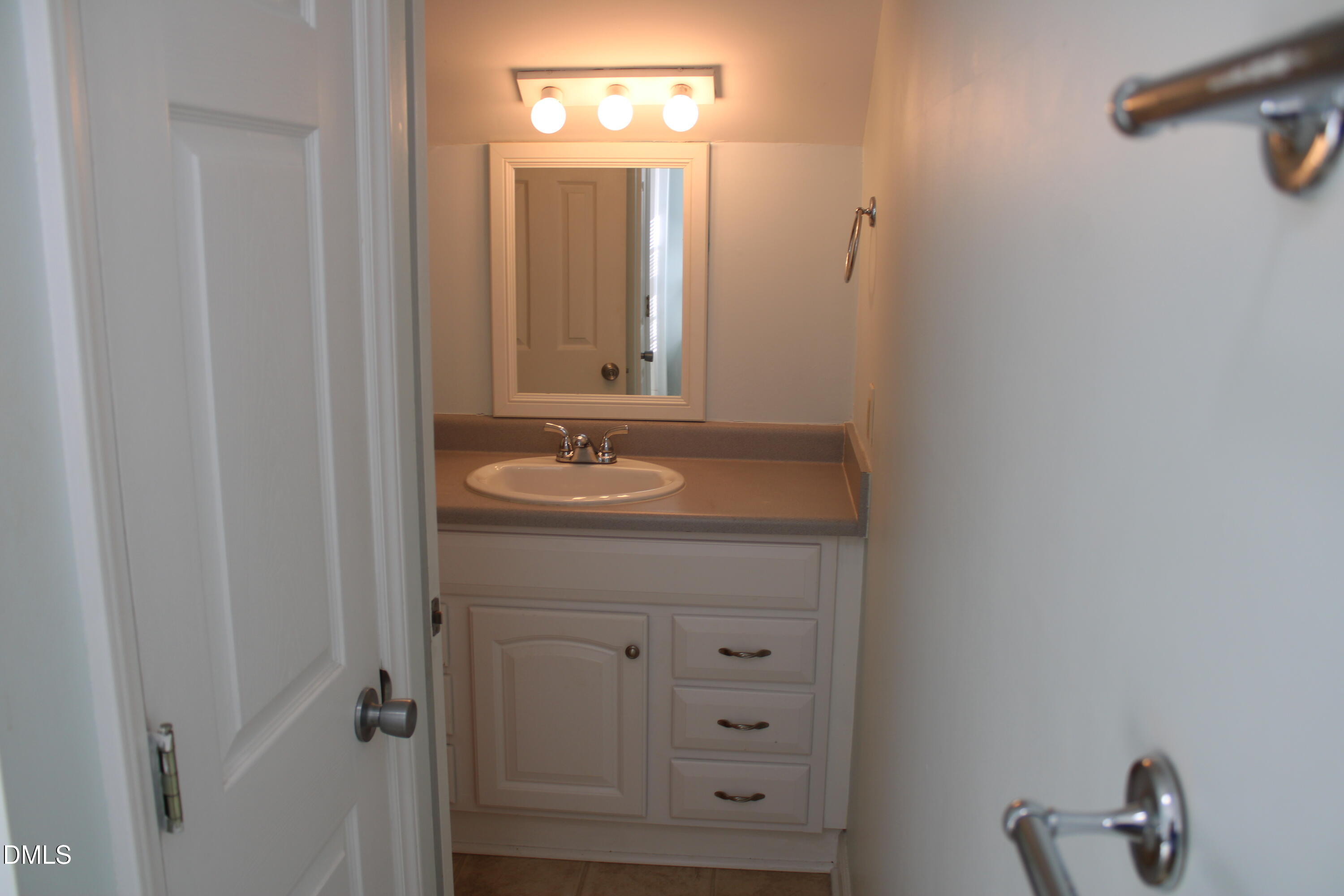 6701 Queen Annes Drive Raleigh, NC 27613 - Photo 17 of 23 a bathroom with a sink vanity and mirror