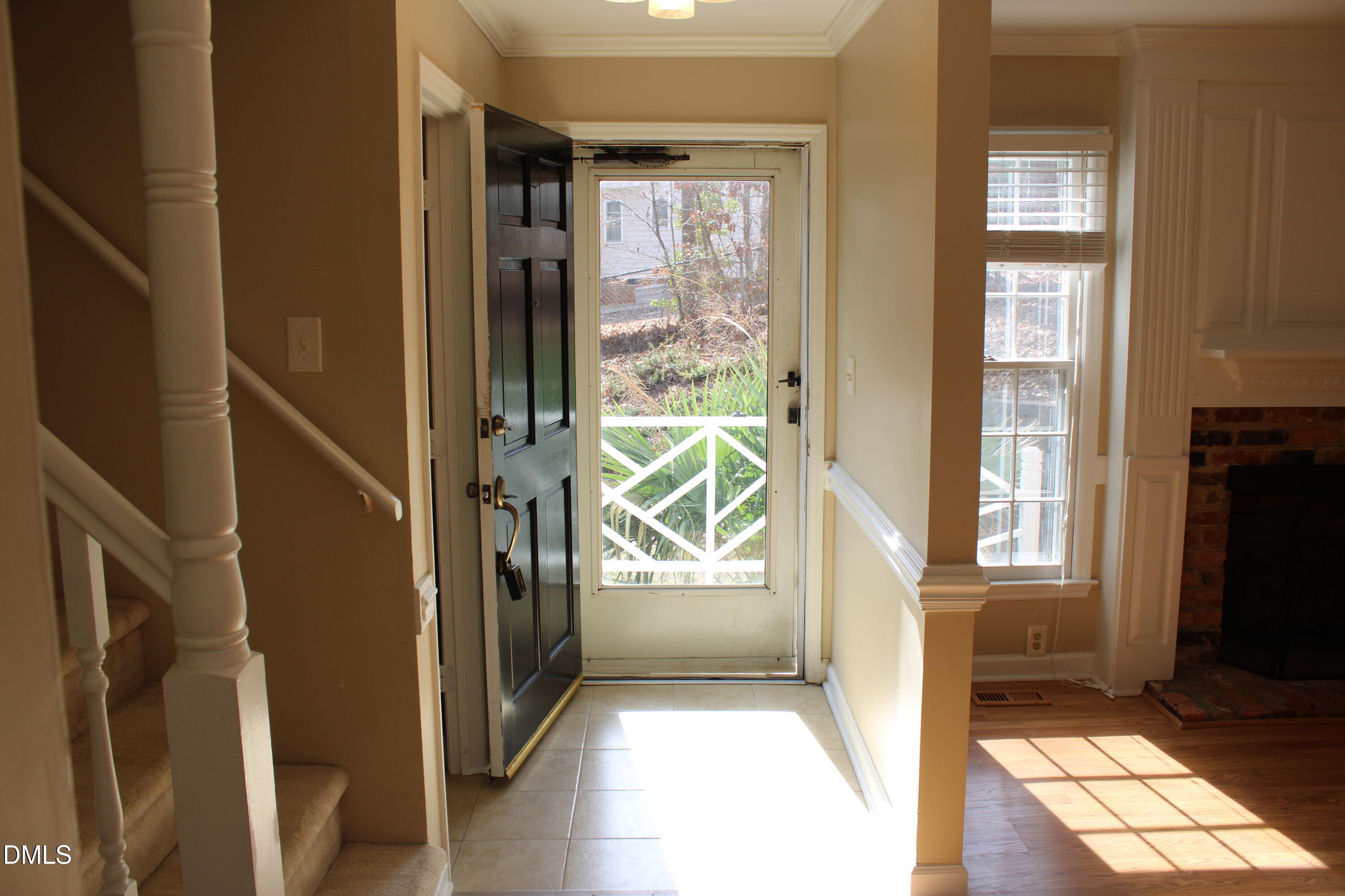 6701 Queen Annes Drive Raleigh, NC 27613 - Photo 3 of 23 a view of an entryway with wooden floor and a livingroom