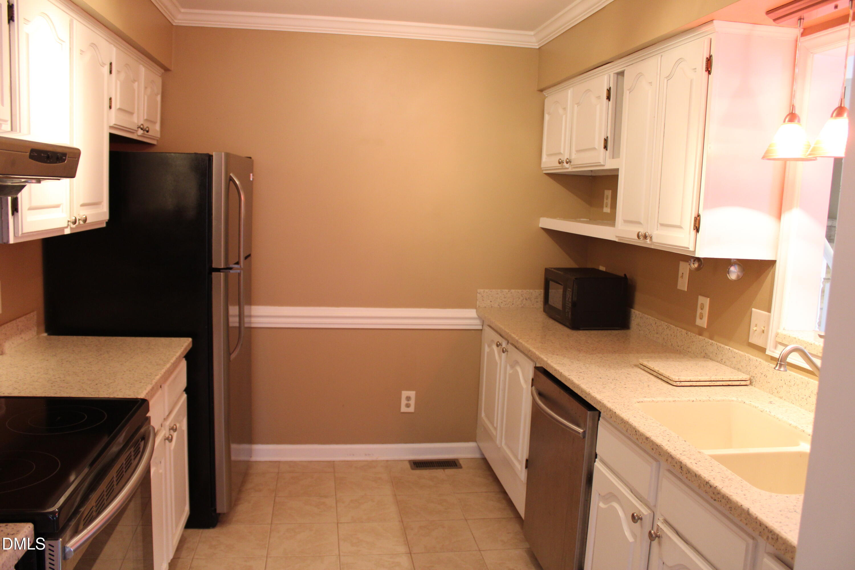 6701 Queen Annes Drive Raleigh, NC 27613 - Photo 6 of 23 a kitchen with a refrigerator and a stove
