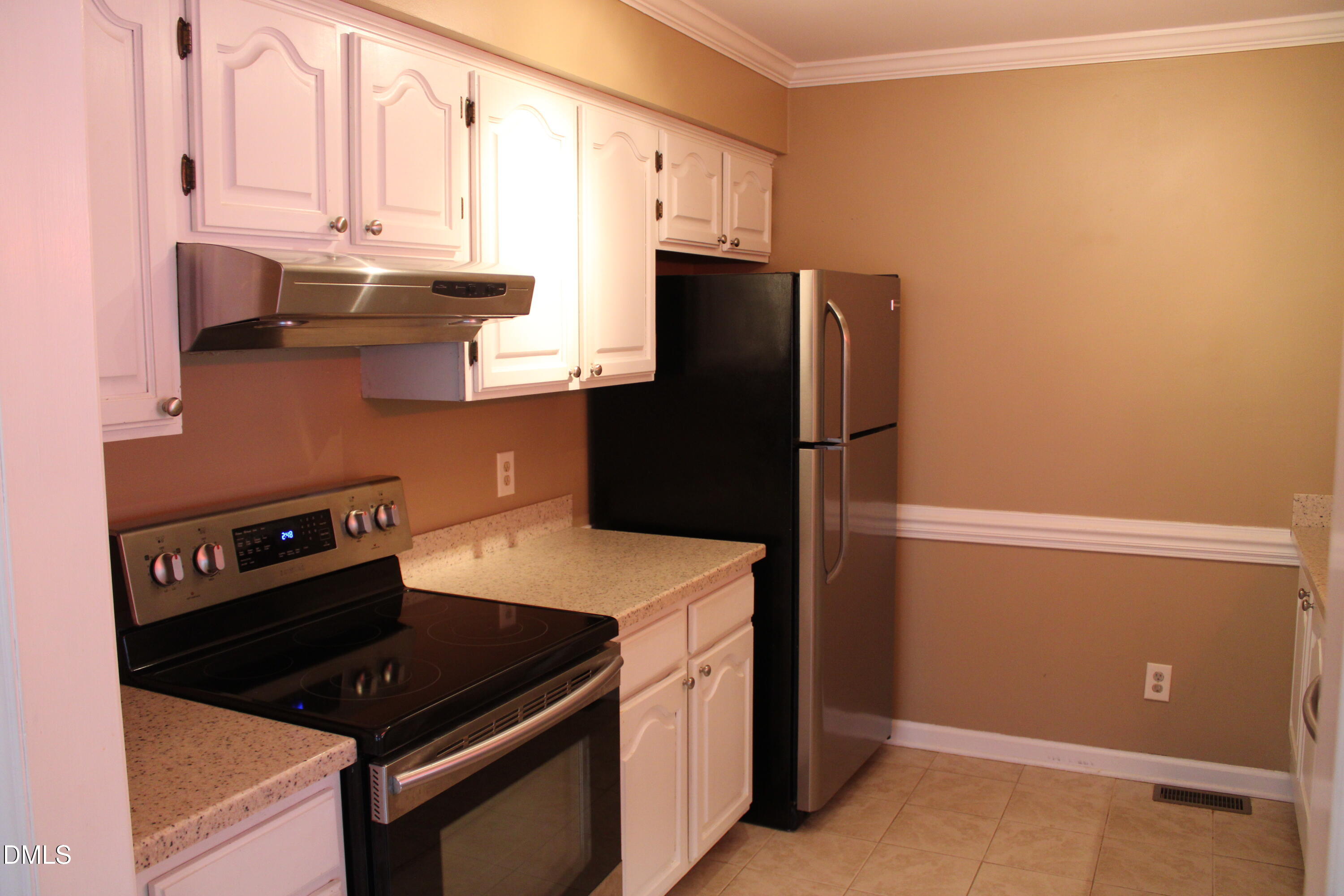 6701 Queen Annes Drive Raleigh, NC 27613 - Photo 7 of 23 a kitchen with stainless steel appliances a refrigerator and a stove