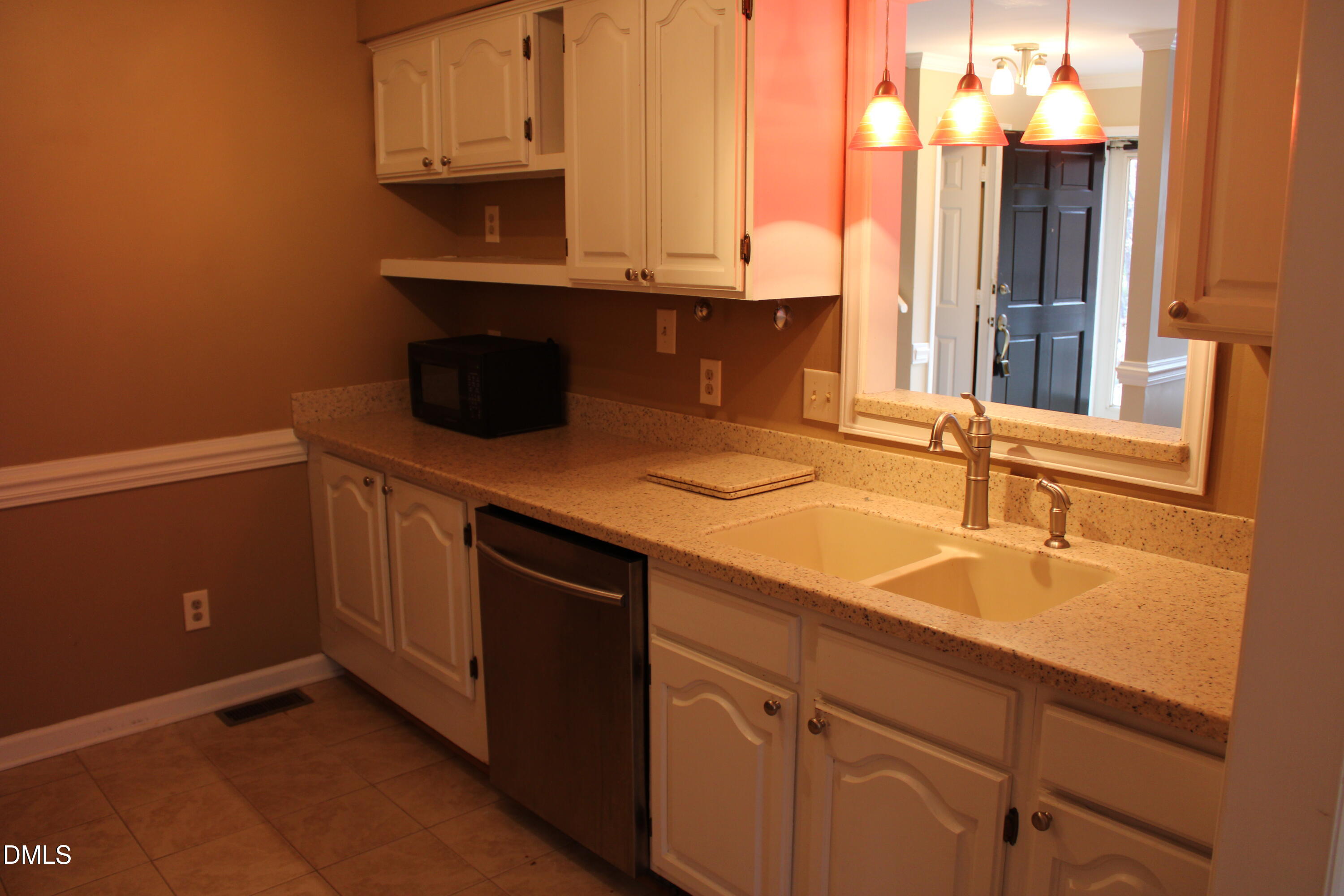 6701 Queen Annes Drive Raleigh, NC 27613 - Photo 8 of 23 a kitchen with stainless steel appliances granite countertop a sink and a microwave