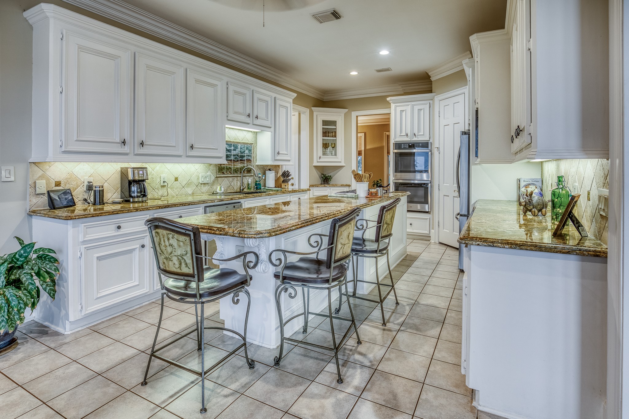 2204 Carter Road Bellville, TX 77418 - Photo 11 of 30 a kitchen with stainless steel appliances kitchen island granite countertop a table chairs sink and cabinets