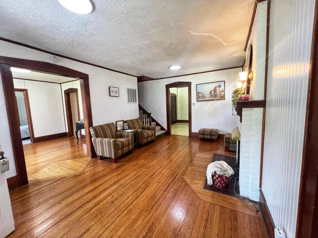a living room with furniture and a wooden floor