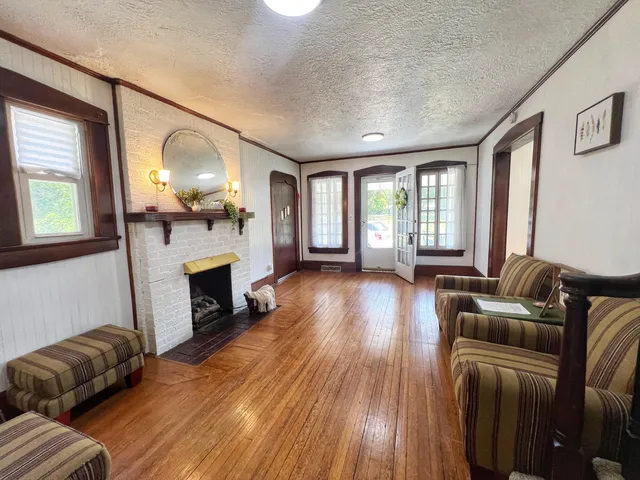 a living room with furniture and a fireplace