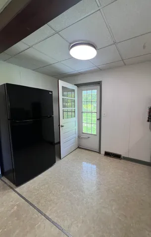 a view of empty room with a fireplace