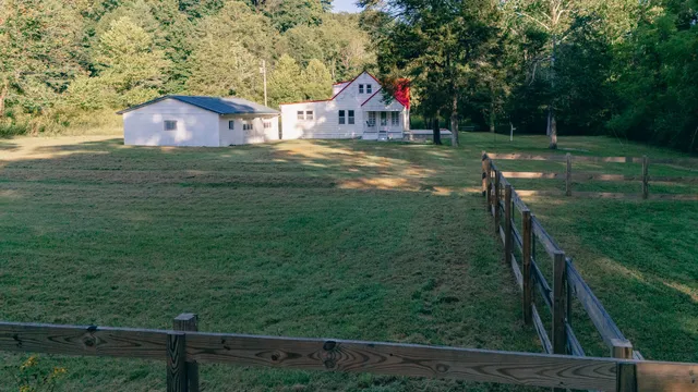a view of house with backyard