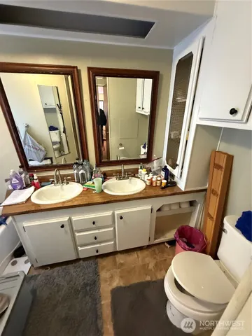 a bathroom with a sink mirror vanity and toilet