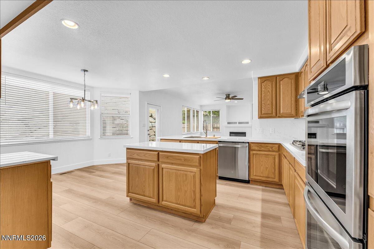 2329 Red Maple Court Reno, NV 89523 - Photo 10 of 39 a kitchen with stainless steel appliances granite countertop a stove and a sink