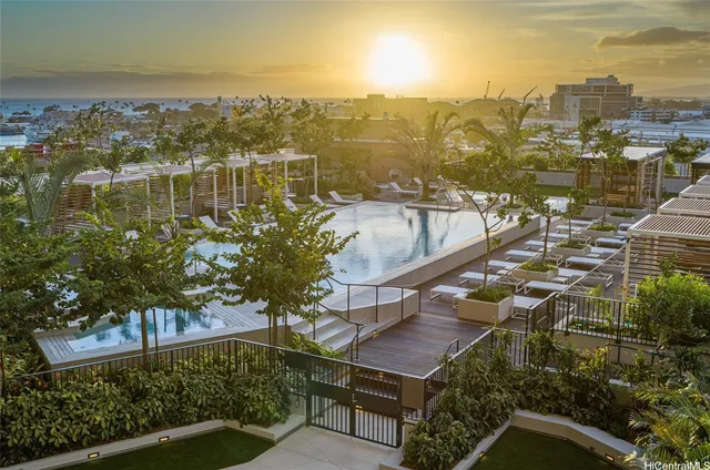 a view of pool with lawn chairs and potted plants