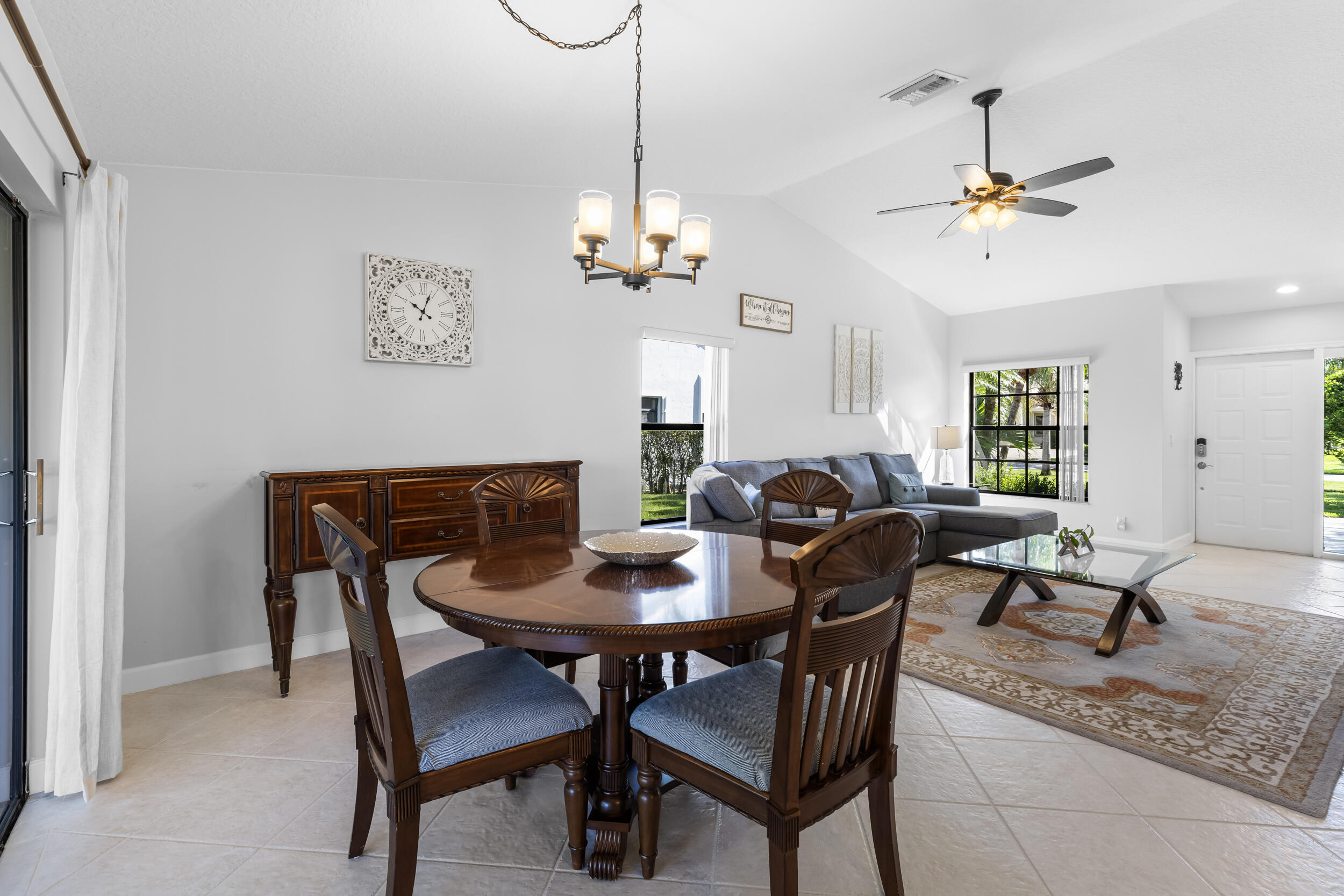 14451 Parker Ridge Court Delray Beach, FL 33484 - Photo 10 of 48 a view of a dining room with furniture a chandelier and wooden floor