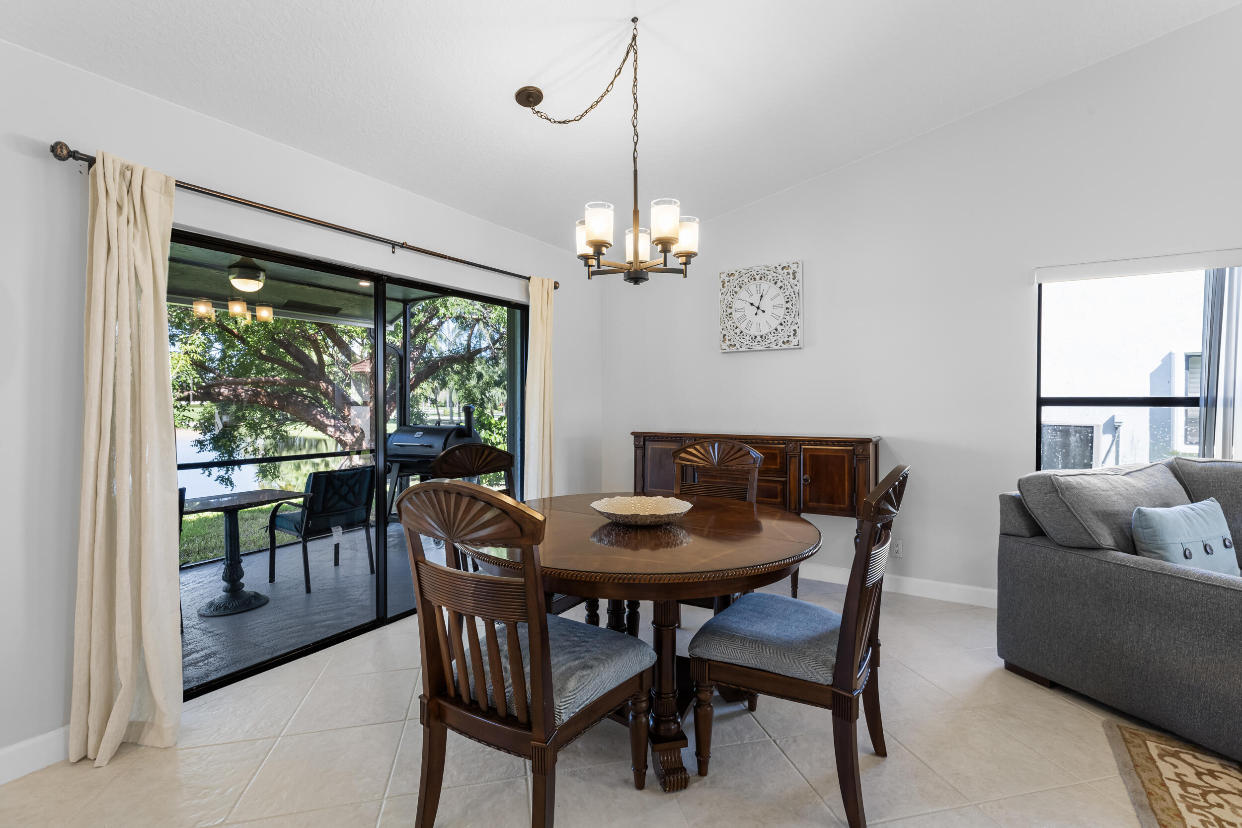 14451 Parker Ridge Court Delray Beach, FL 33484 - Photo 11 of 48 a dining room with furniture a chandelier and a rug