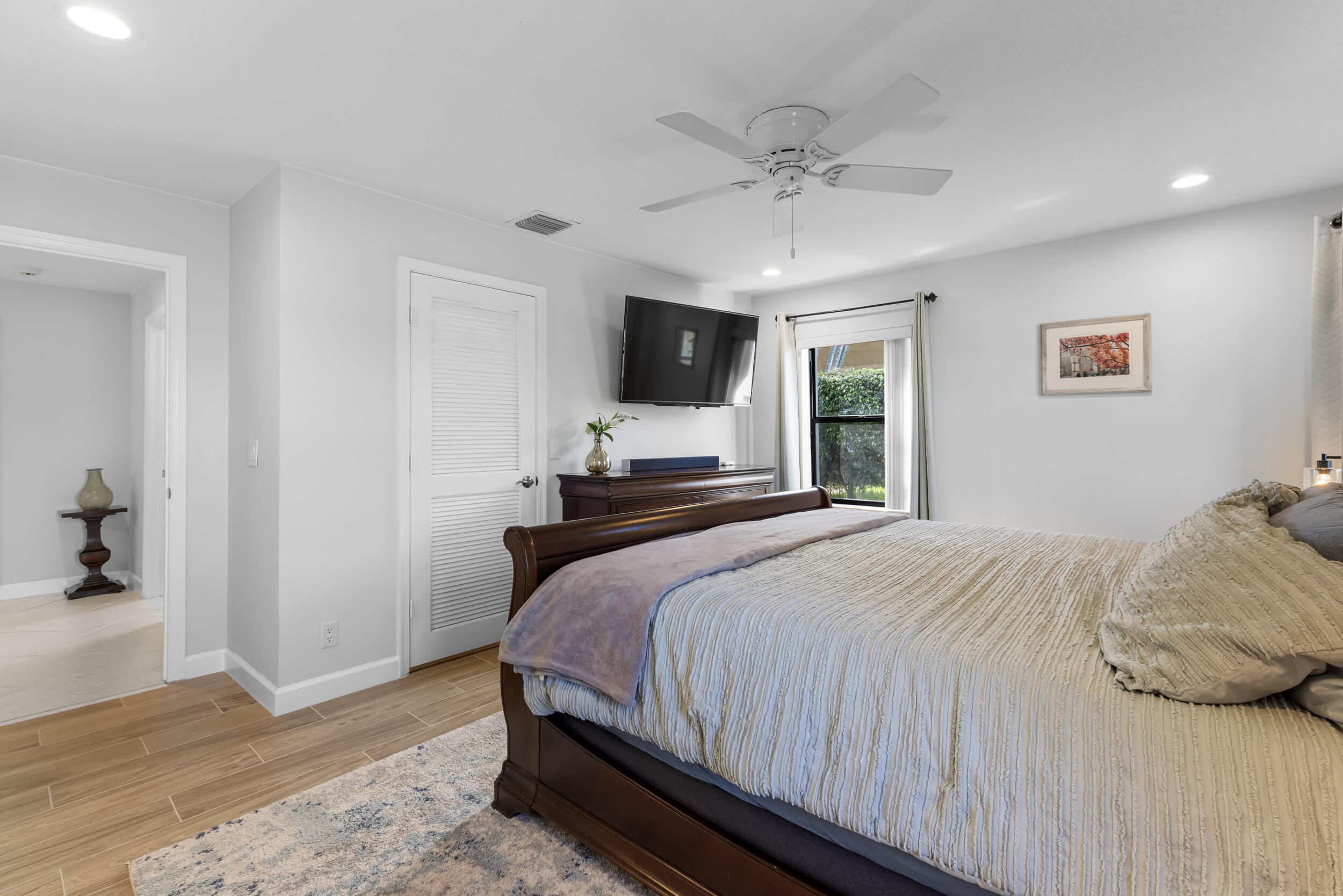 14451 Parker Ridge Court Delray Beach, FL 33484 - Photo 25 of 48 a bedroom with a bed and a flat screen tv