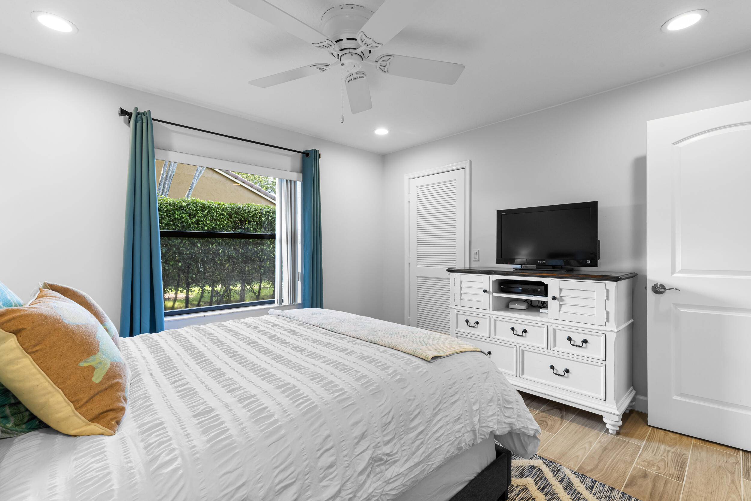 14451 Parker Ridge Court Delray Beach, FL 33484 - Photo 31 of 48 a bedroom with a bed and a flat screen tv