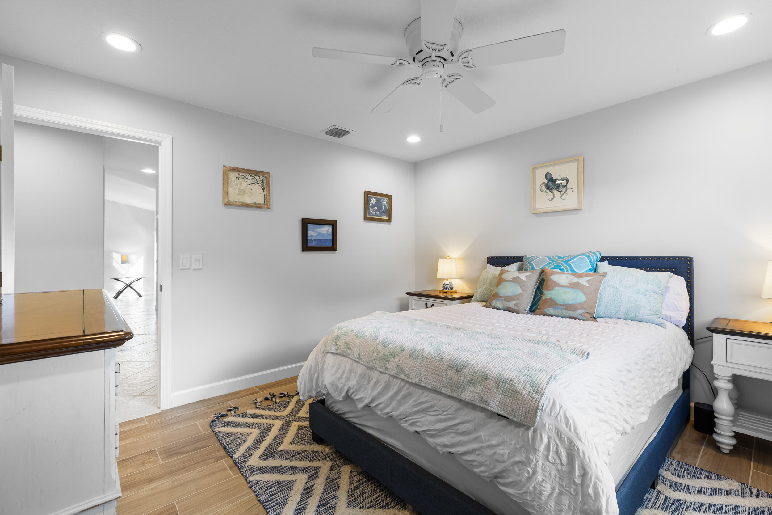 14451 Parker Ridge Court Delray Beach, FL 33484 - Photo 32 of 48 a bedroom with a bed and a chandelier