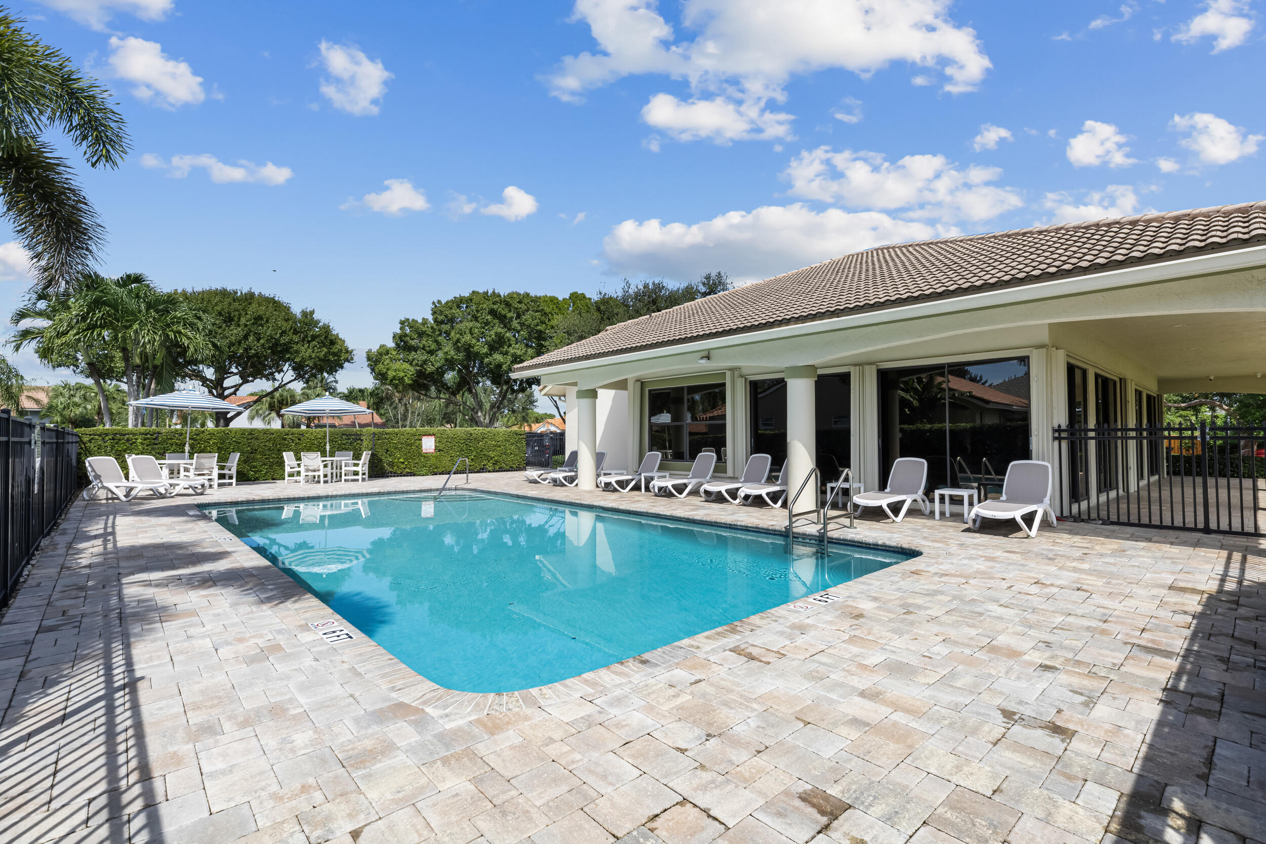 14451 Parker Ridge Court Delray Beach, FL 33484 - Photo 44 of 48 a view of a house with swimming pool and sitting area