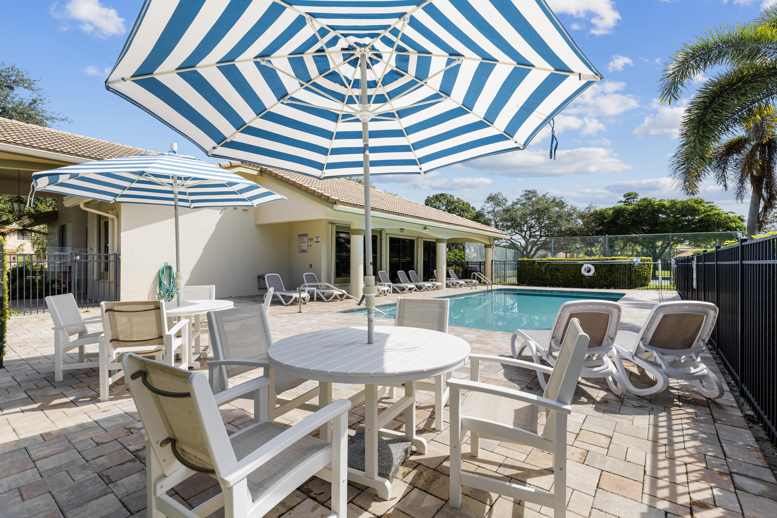 14451 Parker Ridge Court Delray Beach, FL 33484 - Photo 46 of 48 a view of a patio with a table and chairs