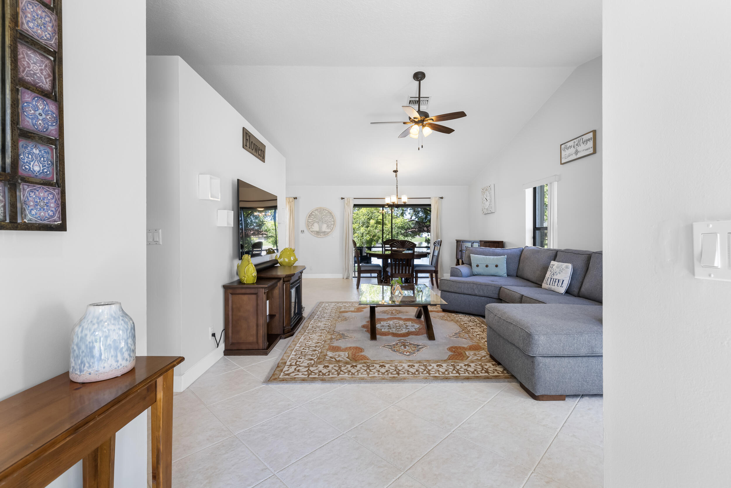 14451 Parker Ridge Court Delray Beach, FL 33484 - Photo 5 of 48 a living room with furniture and a chandelier