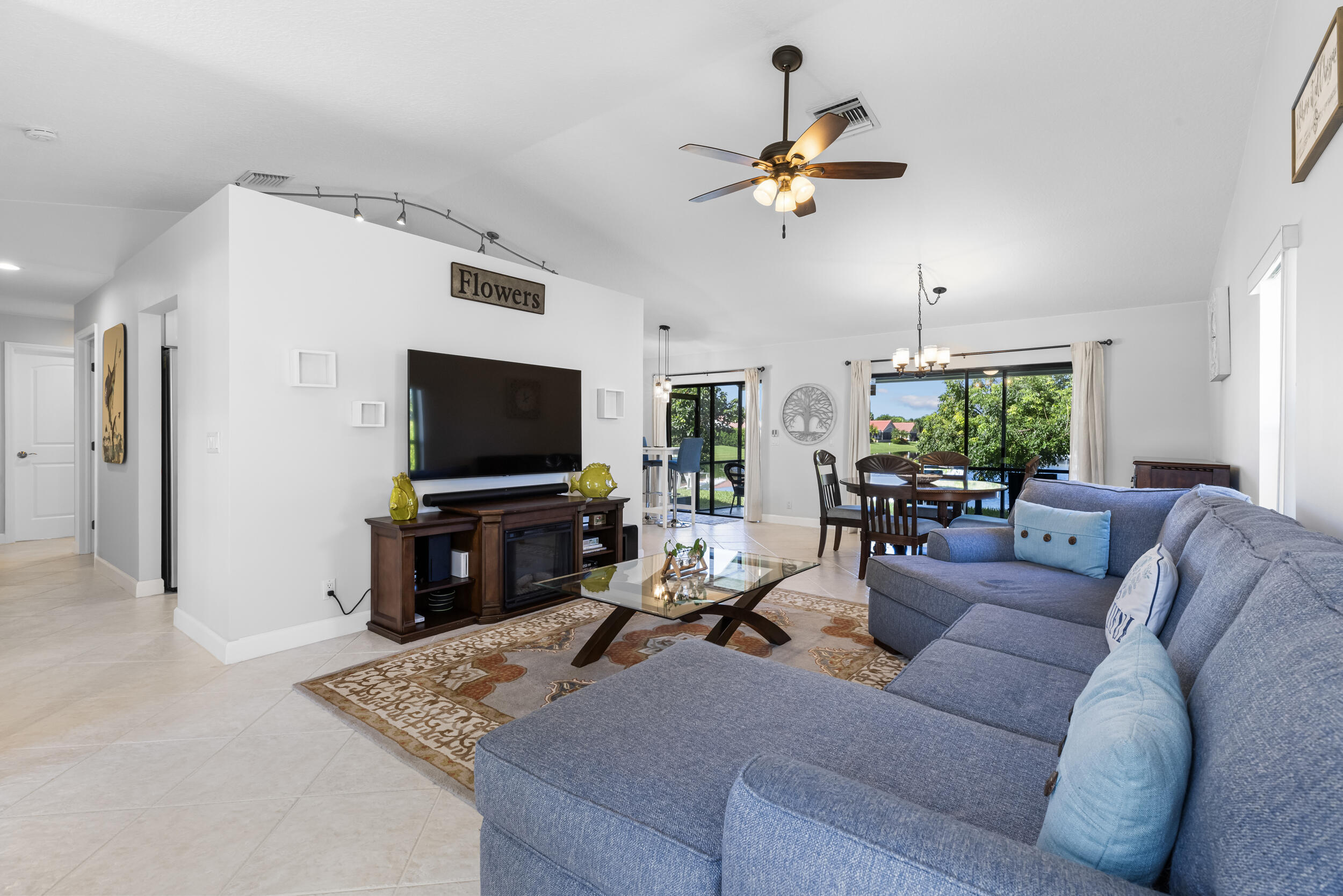 14451 Parker Ridge Court Delray Beach, FL 33484 - Photo 7 of 48 a living room with furniture and a flat screen tv