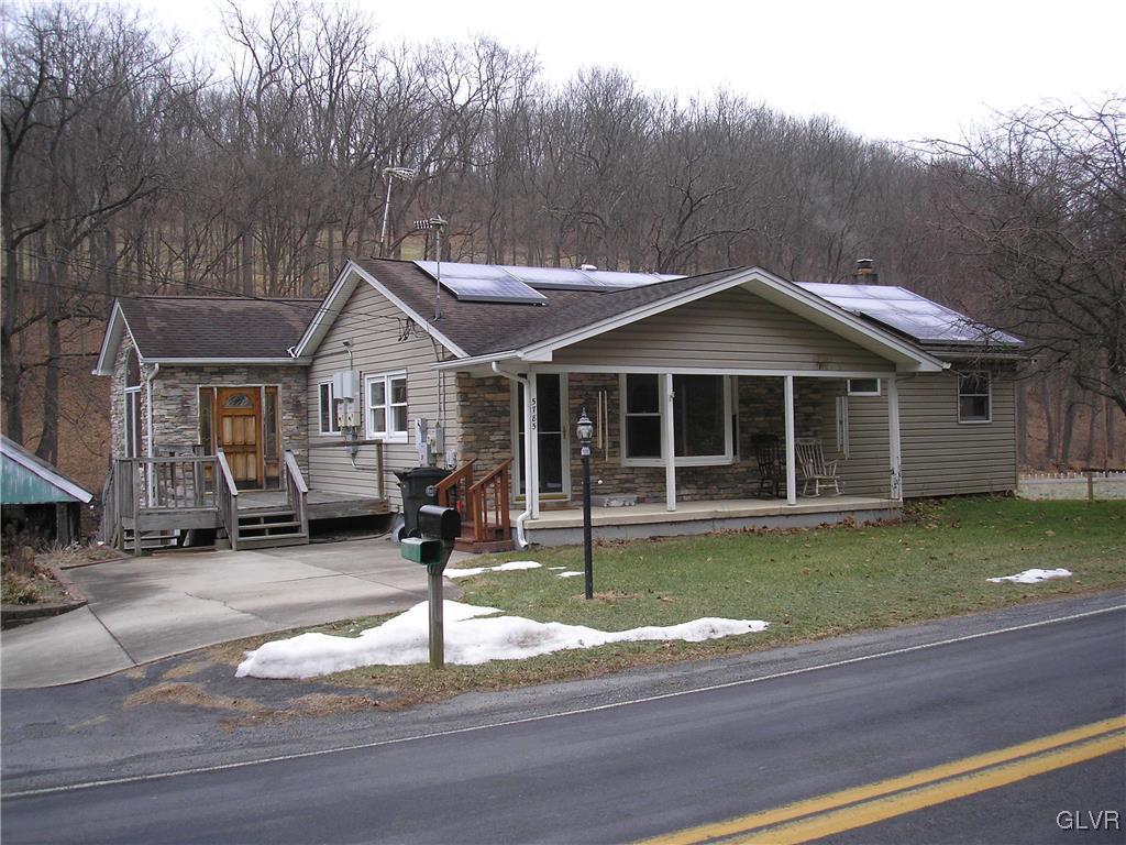5785 Haasadahl Road Orefield, PA 18069 - Photo 1 of 28 a front view of a house with a yard table and chairs