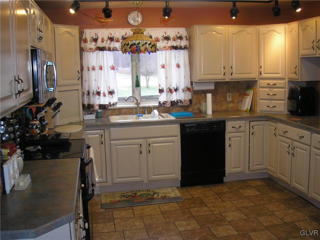 5785 Haasadahl Road Orefield, PA 18069 - Photo 15 of 28 a kitchen with kitchen island granite countertop a sink stove and cabinets
