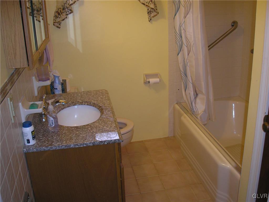 5785 Haasadahl Road Orefield, PA 18069 - Photo 17 of 28 a bathroom with a granite countertop sink a mirror and shower